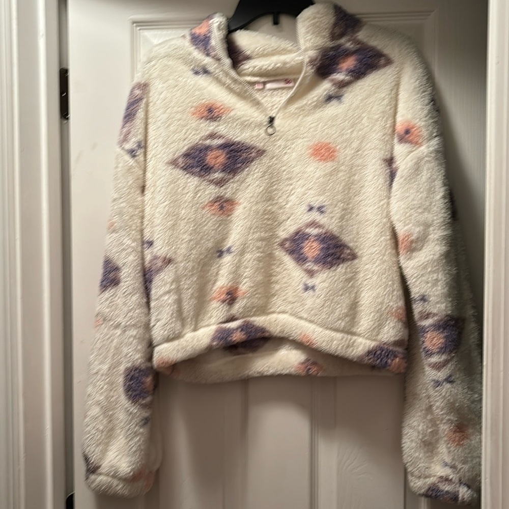 SO cream fuzzy pull over jacket with pink circle and purple diamonds. 1/4 zip
